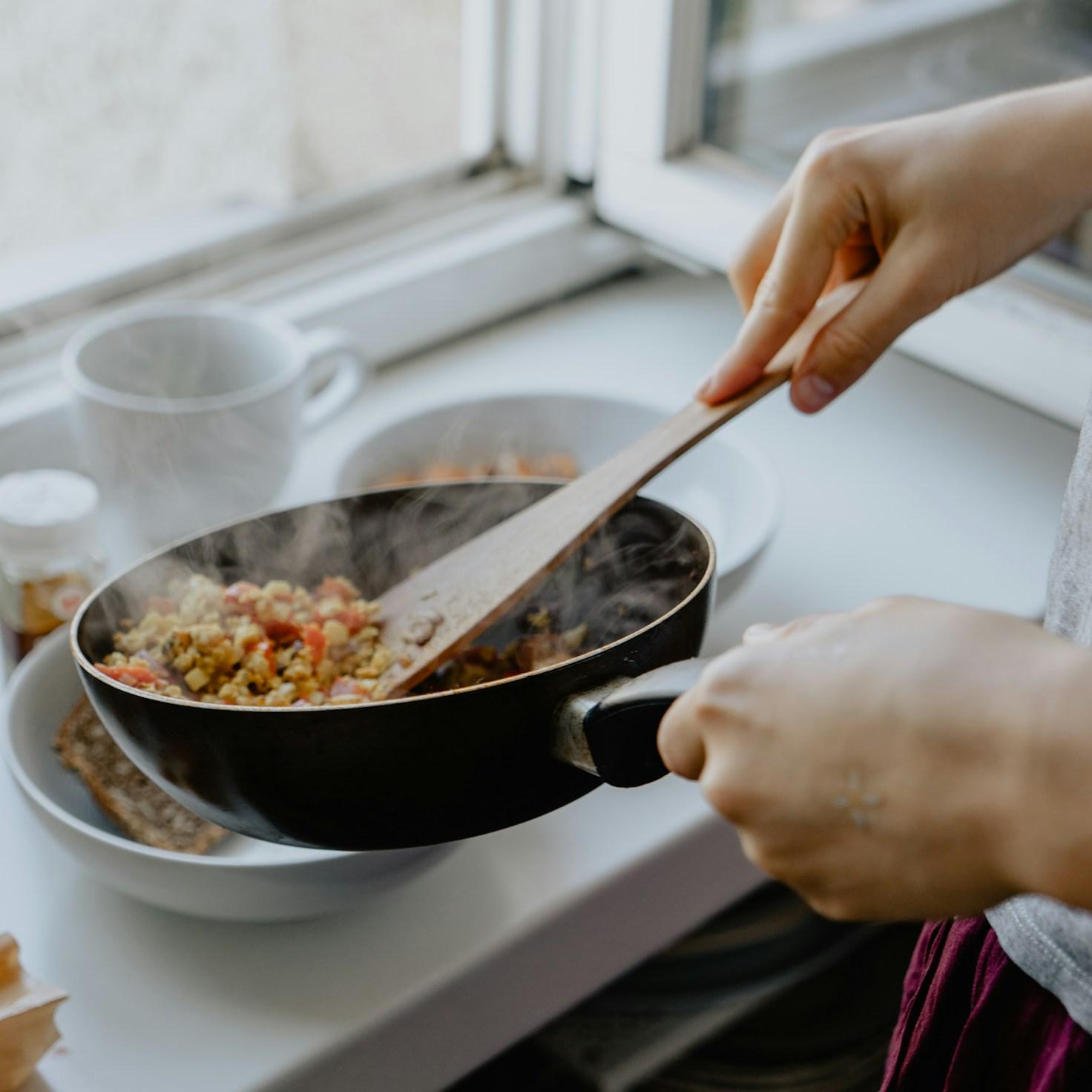 Community members collaborating in a modern kitchen space, sharing recipes and cooking techniques